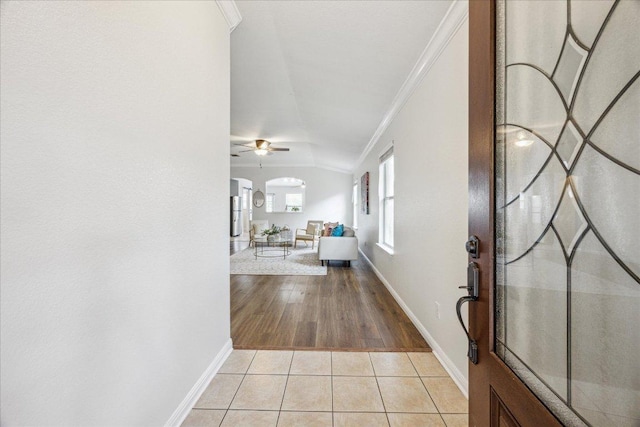 104 Lucky Clover Ln, Hutto, TX 78634 - foyer entrance featuring ornamental molding, baseboards, vaulted ceiling, light tile patterned floors, and a ceiling fan