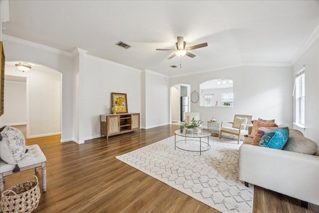 104 Lucky Clover Ln, Hutto, TX 78634 - living area featuring arched walkways, a ceiling fan, wood finished floors, baseboards, and crown molding