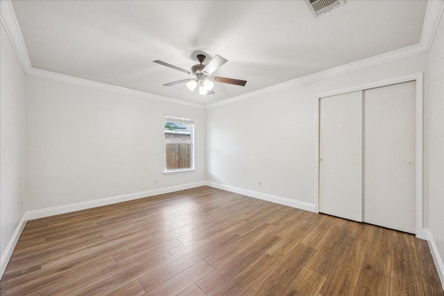 104 Lucky Clover Ln, Hutto, TX 78634 - unfurnished bedroom with wood finished floors, ornamental molding, baseboards, a closet, and a ceiling fan
