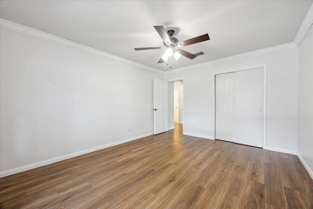104 Lucky Clover Ln, Hutto, TX 78634 - unfurnished bedroom with wood finished floors, crown molding, a closet, and a ceiling fan
