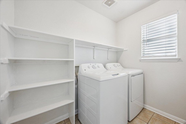 104 Lucky Clover Ln, Hutto, TX 78634 - laundry room featuring independent washer and dryer, baseboards, and light tile patterned flooring