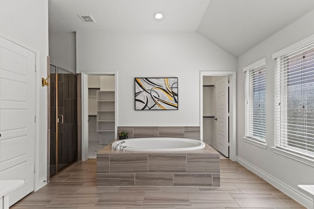 217 Magdalene Way, Liberty Hill, TX 78642 - full bathroom featuring a garden tub, a shower stall, and vaulted ceiling