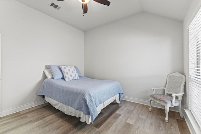 217 Magdalene Way, Liberty Hill, TX 78642 - bedroom with lofted ceiling, wood finished floors, multiple windows, and a ceiling fan