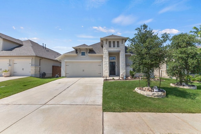 217 Magdalene Way, Liberty Hill, TX 78642 - prairie-style house with stone siding, a front lawn, concrete driveway, a garage, and stucco siding