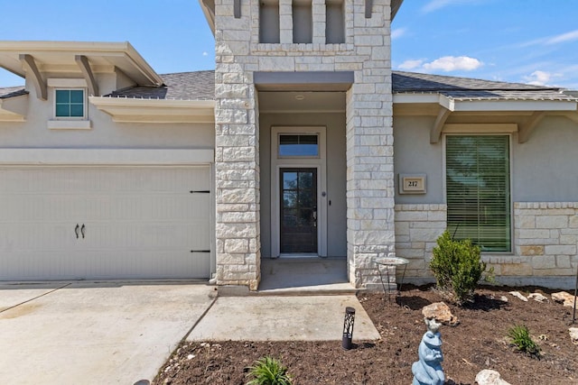 217 Magdalene Way, Liberty Hill, TX 78642 - doorway to property with stone siding, driveway, roof with shingles, and stucco siding