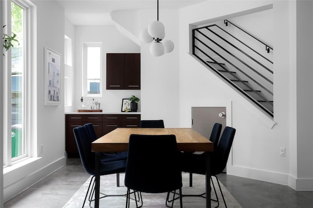 611 Fletcher St, Austin, TX 78704 - dining room featuring concrete floors, baseboards, wet bar, and stairs