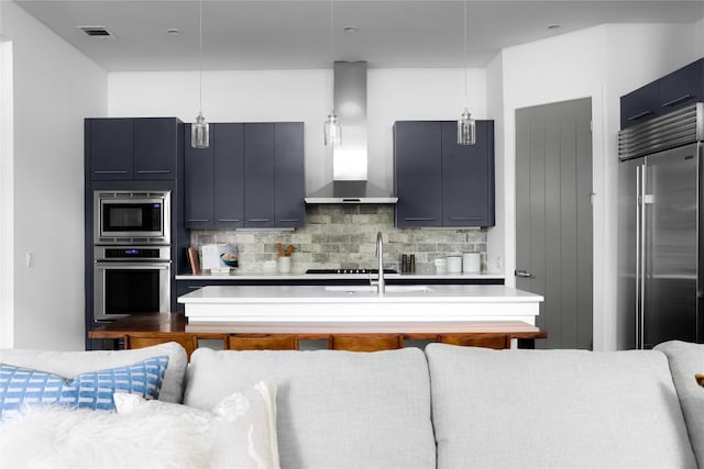 611 Fletcher St, Austin, TX 78704 - kitchen with stainless steel appliances, wall chimney range hood, tasteful backsplash, and light countertops