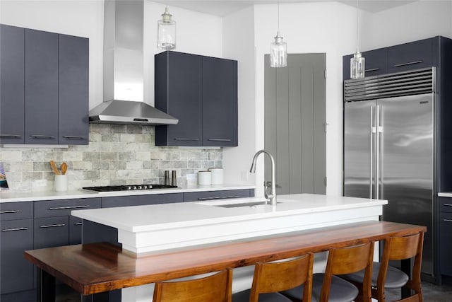 611 Fletcher St, Austin, TX 78704 - kitchen featuring wall chimney range hood, stainless steel built in fridge, a sink, gas stovetop, and a breakfast bar area