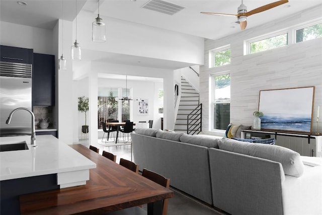611 Fletcher St, Austin, TX 78704 - living room with stairway, a ceiling fan, and a chandelier