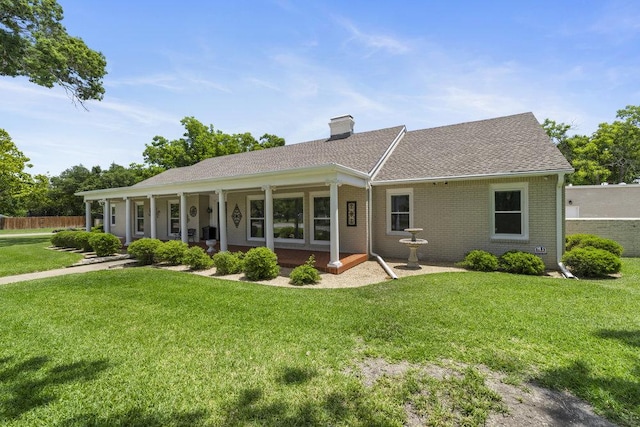 707 W Thompson Ave, Temple, TX 76501 - view of front facade with a chimney, brick siding, and a shingled roof