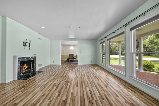 707 W Thompson Ave, Temple, TX 76501 - unfurnished living room featuring wood finished floors, plenty of natural light, baseboards, and recessed lighting