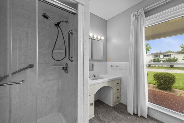 707 W Thompson Ave, Temple, TX 76501 - full bath with tile walls, a shower stall, vanity, and wainscoting