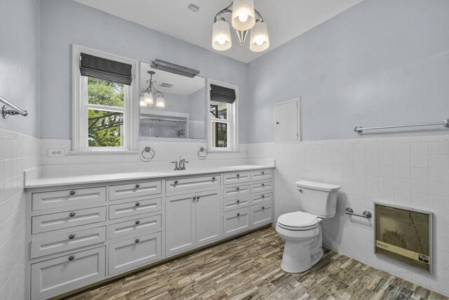 707 W Thompson Ave, Temple, TX 76501 - full bathroom with tile walls, toilet, vanity, plenty of natural light, and a wainscoted wall