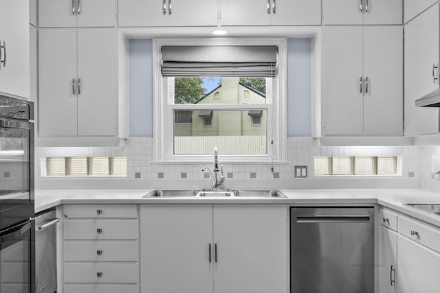 707 W Thompson Ave, Temple, TX 76501 - kitchen with dishwasher, a sink, decorative backsplash, and white cabinetry