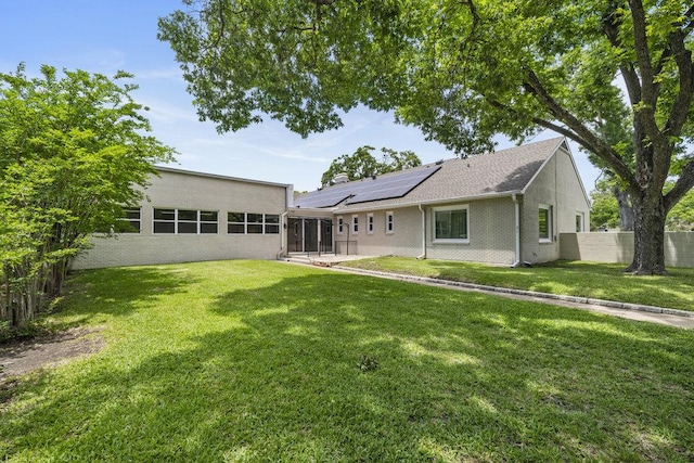 707 W Thompson Ave, Temple, TX 76501 - rear view of house featuring a sunroom and solar panels