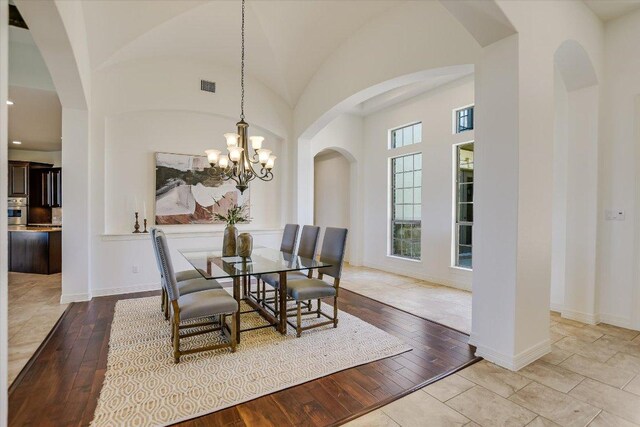 598 Naples Ln, Austin, TX 78737 - dining area with hardwood / wood-style floors, baseboards, recessed lighting, a chandelier, and a towering ceiling