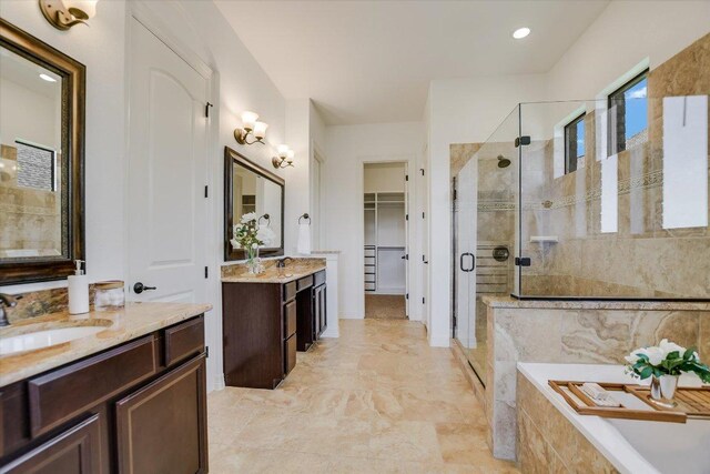 598 Naples Ln, Austin, TX 78737 - full bathroom featuring a shower stall, two vanities, a garden tub, and a walk in closet