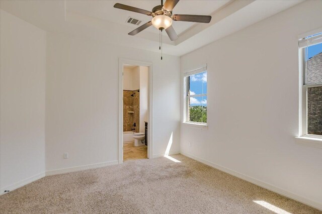 598 Naples Ln, Austin, TX 78737 - empty room featuring light carpet, healthy amount of natural light, a tray ceiling, and a ceiling fan