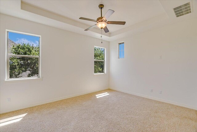 598 Naples Ln, Austin, TX 78737 - carpeted empty room with a tray ceiling, ceiling fan, and baseboards