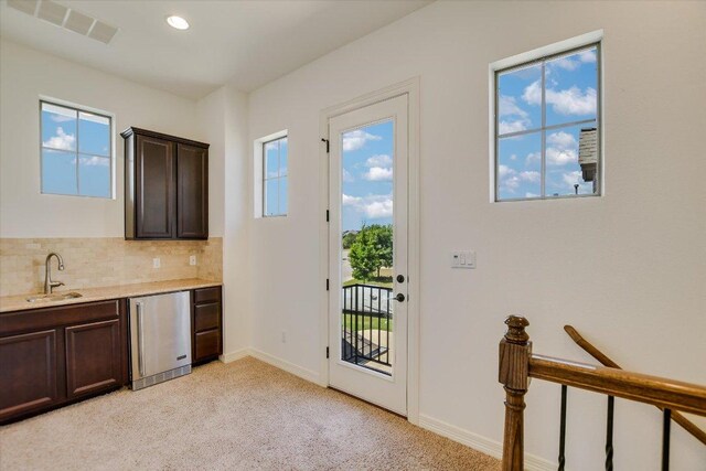 598 Naples Ln, Austin, TX 78737 - kitchen with a sink, refrigerator, dark brown cabinets, light carpet, and recessed lighting