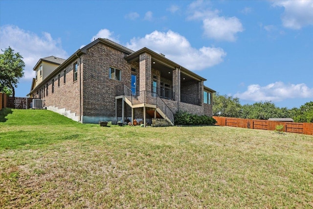 598 Naples Ln, Austin, TX 78737 - rear view of property with brick siding, stairs, and a fenced backyard