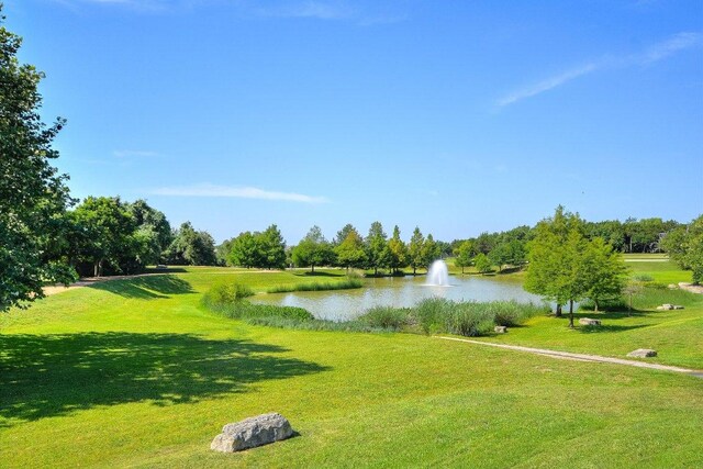 598 Naples Ln, Austin, TX 78737 - view of property's community featuring a water view and a lawn