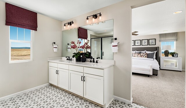 20406 Stelfox St, Manor, TX 78653 - ensuite bathroom featuring plenty of natural light, baseboards, and double vanity