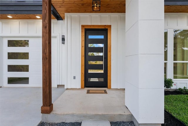 121 Mokolii Ct, Bastrop, TX 78602 - property entrance with board and batten siding and an attached garage