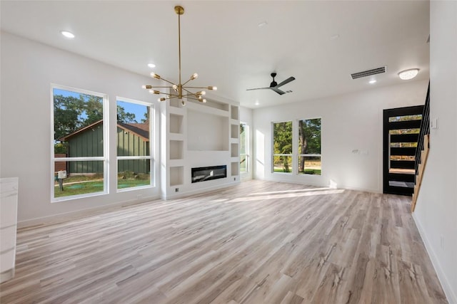 121 Mokolii Ct, Bastrop, TX 78602 - unfurnished living room featuring stairs, healthy amount of natural light, light wood-style flooring, recessed lighting, and built in shelves