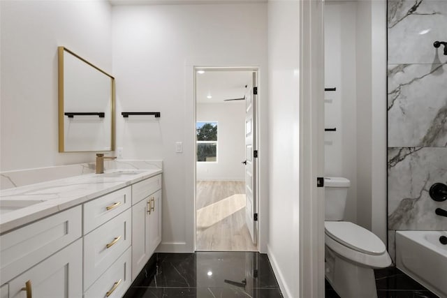 121 Mokolii Ct, Bastrop, TX 78602 - bathroom with double vanity, toilet, baseboards, granite tiled floors, and washtub / shower combination