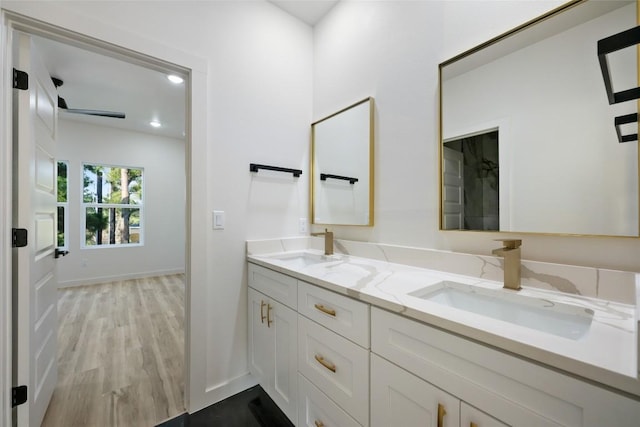 121 Mokolii Ct, Bastrop, TX 78602 - bathroom featuring double vanity, wood finished floors, and baseboards