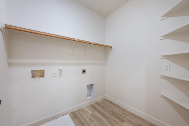 121 Mokolii Ct, Bastrop, TX 78602 - washroom with light wood-type flooring, hookup for an electric dryer, hookup for a washing machine, baseboards, and hookup for a gas dryer