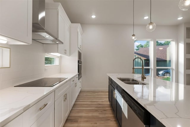 121 Mokolii Ct, Bastrop, TX 78602 - kitchen with wall chimney exhaust hood, a sink, stainless steel dishwasher, black electric stovetop, and light wood finished floors