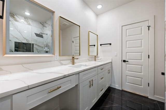 121 Mokolii Ct, Bastrop, TX 78602 - bathroom with double vanity, a marble finish shower, and recessed lighting