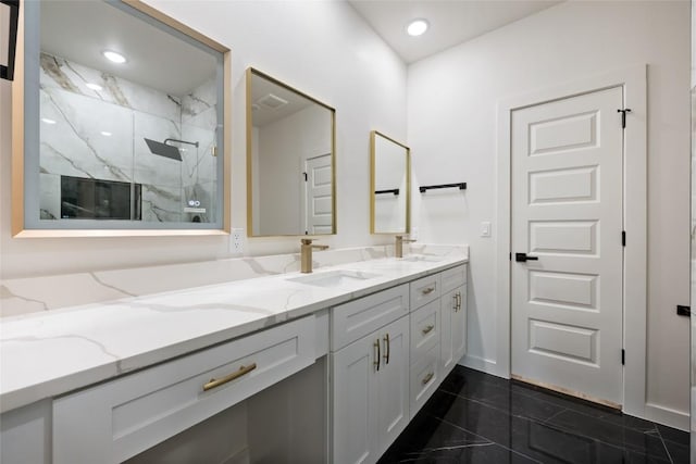 121 Mokolii Ct, Bastrop, TX 78602 - bathroom with double vanity, a marble finish shower, and recessed lighting