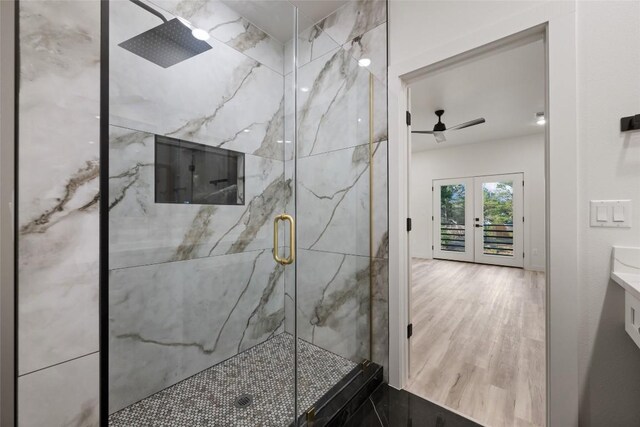 121 Mokolii Ct, Bastrop, TX 78602 - bathroom with a marble finish shower, ceiling fan, french doors, vanity, and wood finished floors