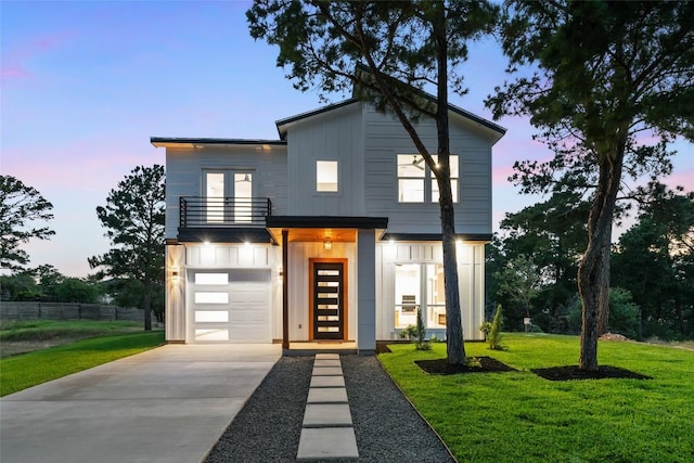 121 Mokolii Ct, Bastrop, TX 78602 - modern home featuring a balcony, concrete driveway, an attached garage, board and batten siding, and french doors