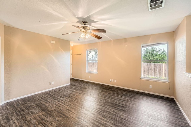 16321 Hamilton Point Cir, Manor, TX 78653 - spare room featuring plenty of natural light, ceiling fan, wood finished floors, baseboards, and a textured wall