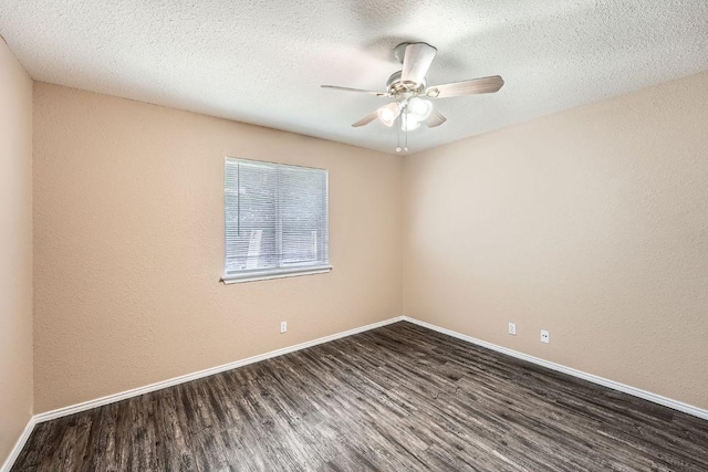 16321 Hamilton Point Cir, Manor, TX 78653 - empty room featuring dark wood-type flooring, baseboards, a textured ceiling, and ceiling fan