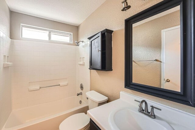 16321 Hamilton Point Cir, Manor, TX 78653 - bathroom featuring toilet, vanity, shower / bath combination, a textured wall, and a textured ceiling
