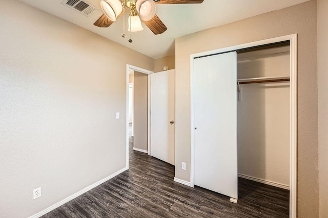 16321 Hamilton Point Cir, Manor, TX 78653 - unfurnished bedroom with dark wood finished floors, a closet, baseboards, and ceiling fan