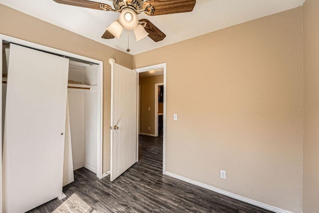 16321 Hamilton Point Cir, Manor, TX 78653 - unfurnished bedroom featuring dark wood finished floors, a closet, baseboards, and a ceiling fan