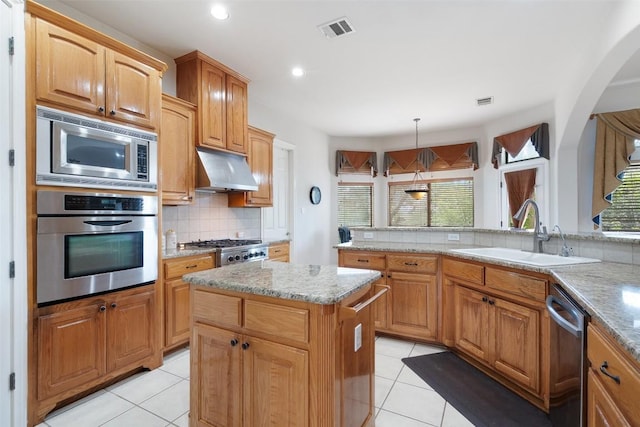 9904 Chester Cv, Austin, TX 78750 - kitchen featuring stainless steel appliances, backsplash, light tile patterned flooring, a center island, and recessed lighting