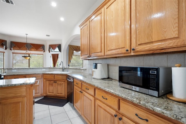 9904 Chester Cv, Austin, TX 78750 - kitchen featuring stainless steel dishwasher, a sink, tasteful backsplash, light stone countertops, and recessed lighting