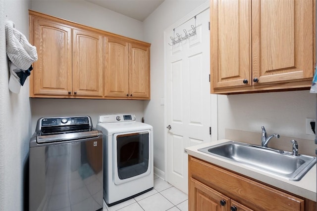 9904 Chester Cv, Austin, TX 78750 - laundry room with cabinet space, washer and dryer, and light tile patterned flooring