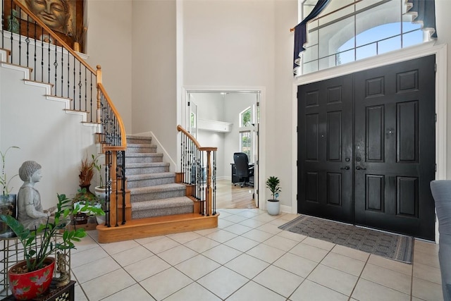 9904 Chester Cv, Austin, TX 78750 - tiled foyer with a towering ceiling, stairs, and baseboards