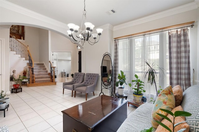 9904 Chester Cv, Austin, TX 78750 - living room featuring stairway, a chandelier, ornamental molding, light tile patterned floors, and arched walkways
