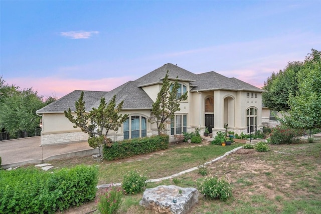 9904 Chester Cv, Austin, TX 78750 - french country inspired facade with stucco siding, stone siding, and a shingled roof