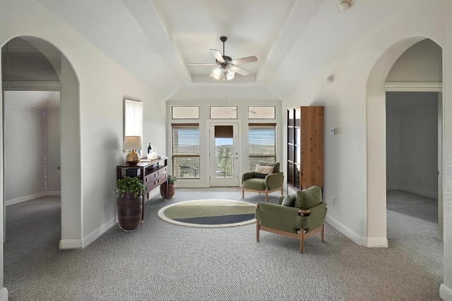 9904 Chester Cv, Austin, TX 78750 - living area with carpet, a ceiling fan, arched walkways, and a tray ceiling