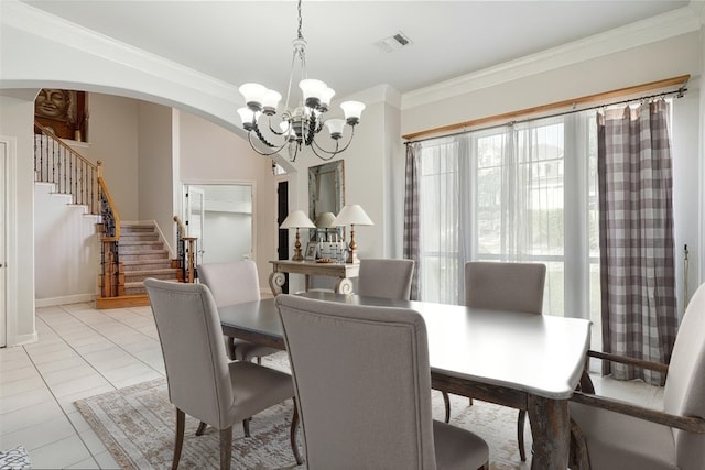 9904 Chester Cv, Austin, TX 78750 - dining area featuring a chandelier, stairway, crown molding, and arched walkways